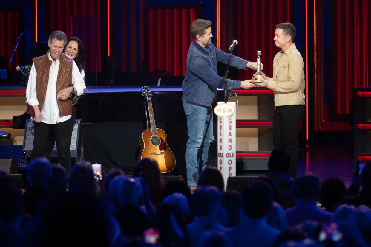 Randy Travis accompanied by his wife, Mary Davis, Josh Turner and Scotty McCreery, onstage at the Grand Ole Opry, April 20, 2024