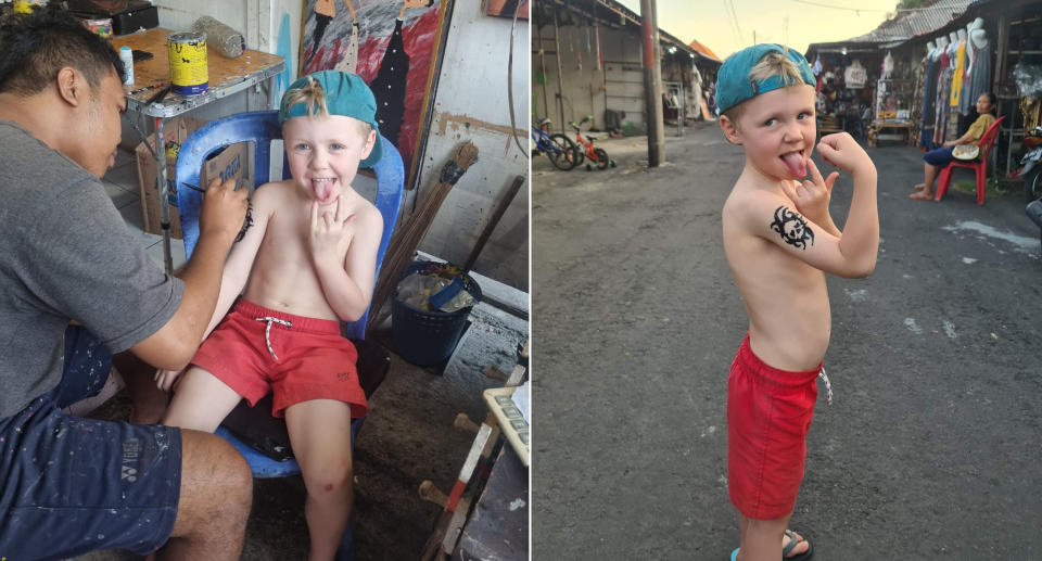 Four-year-old Riley gets a henna tattoo from a Bali market stall.