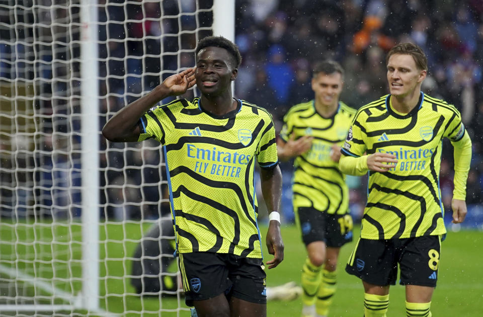 Arsenal's Bukayo Saka celebrates scoring his side's third goal of the game, during the English Premier League soccer match between Burnley and Arsenal, at Turf Moor, in Burnley, England, Saturday, Feb. 17, 2024. (Peter Byrne/PA via AP)