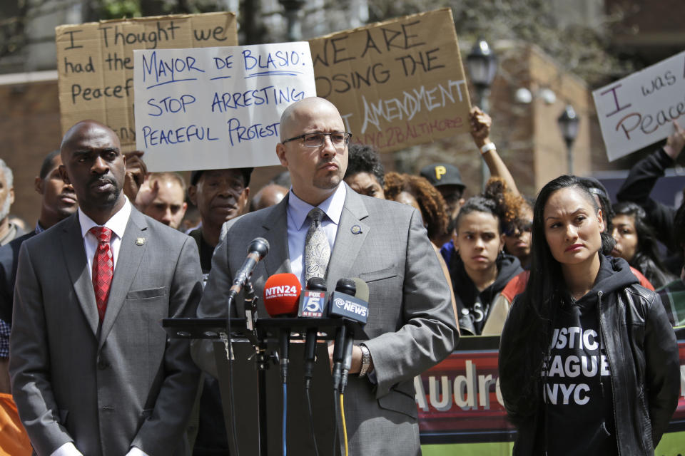 State Assemblyman Michael Blake, left, and state Seb Gustavo Rivera, center, speak to reporters during a news conference in front of New York City Police headquarters, Thursday, April 30, 2015, in New York, to demand an end to violent, hyper-aggressive policing. (Mary Altaffer/AP Photo)