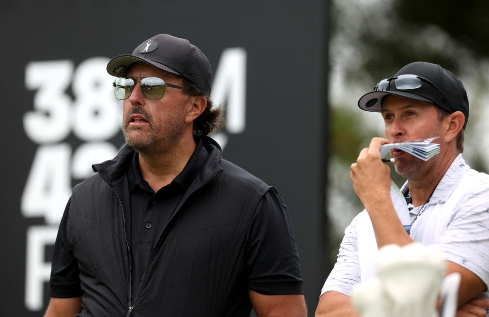 Phil Mickelson of the U.S. with his caddie during the first round Action at the inaugural LIV Golf Invitational event at the Centurion Club in Hemel Hempstead, St Albans, Britain on June 9, 2022. (Reuters/Paul Childs)