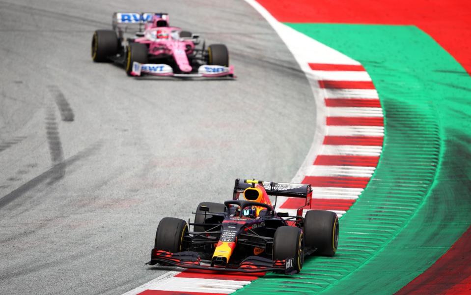 Alexander Albon of Thailand driving the (23) Aston Martin Red Bull Racing RB16 leads Sergio Perez of Mexico driving the (11) Racing Point RP20 Mercedes during the Formula One Grand Prix of Styria at Red Bull Ring on July 12, 2020 in Spielberg, Austria - Getty Images Europe