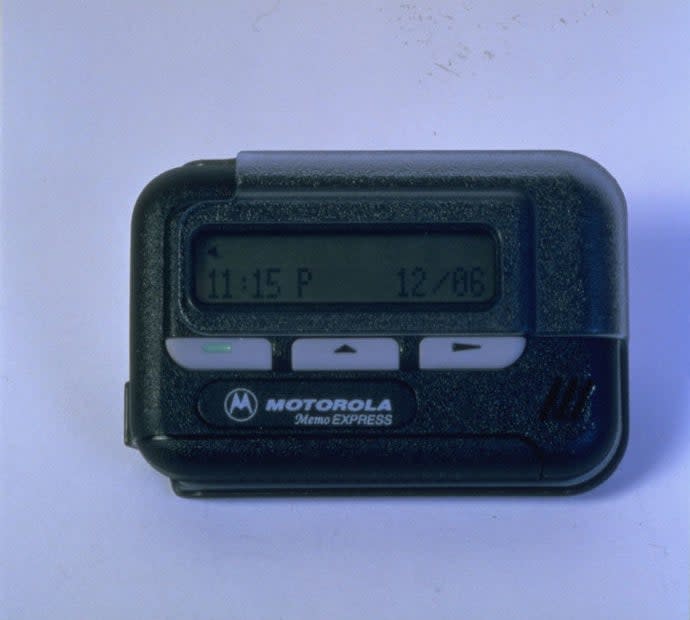 Motorola pager displaying time and date, related to communication in work environments