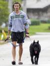 <p>Shawn Mendes walks his dog in the rain on Thursday in Miami. </p>