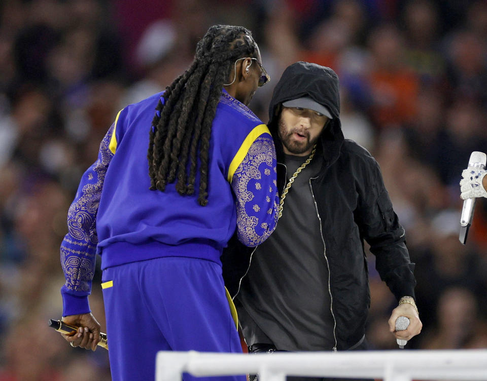 Snoop Dogg (pictured left) and Eminem (pictured right) shake hands at the Super Bowl half-time show.