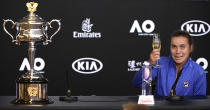 Sofia Kenin of the U.S. holds a glass of champagne during a press conference following her win over Spain's Garbine Muguruza in the women's final at the Australian Open tennis championship in Melbourne, Australia, Saturday, Feb. 1, 2020. (AP Photo/Andy Brownbill)