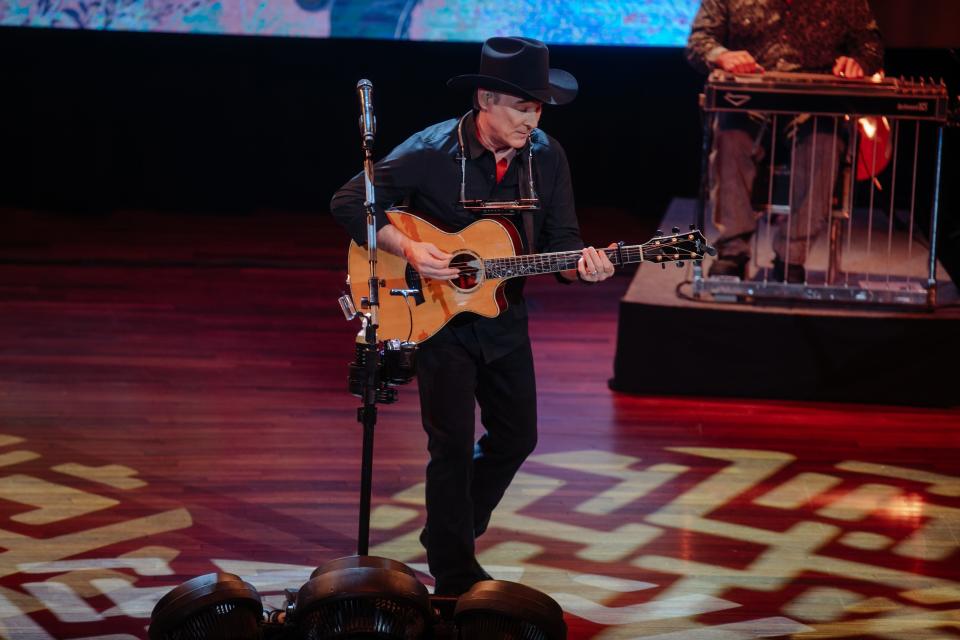 Clint Black playing guitar on the Ryman stage, Feb. 2024