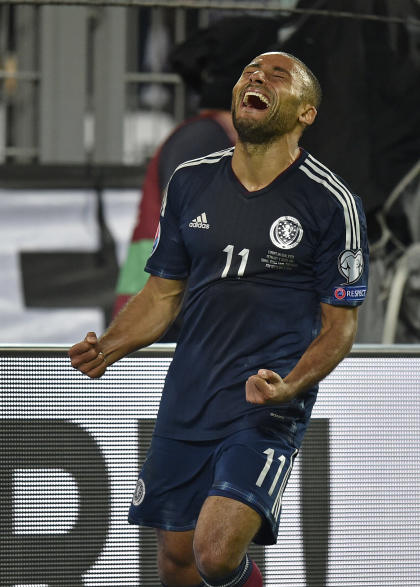 Scotland's Ikechi Anya celebrates after scoring during the Euro 2016 soccer qualifying vs. Germany (AP Photo/Martin Meissner)