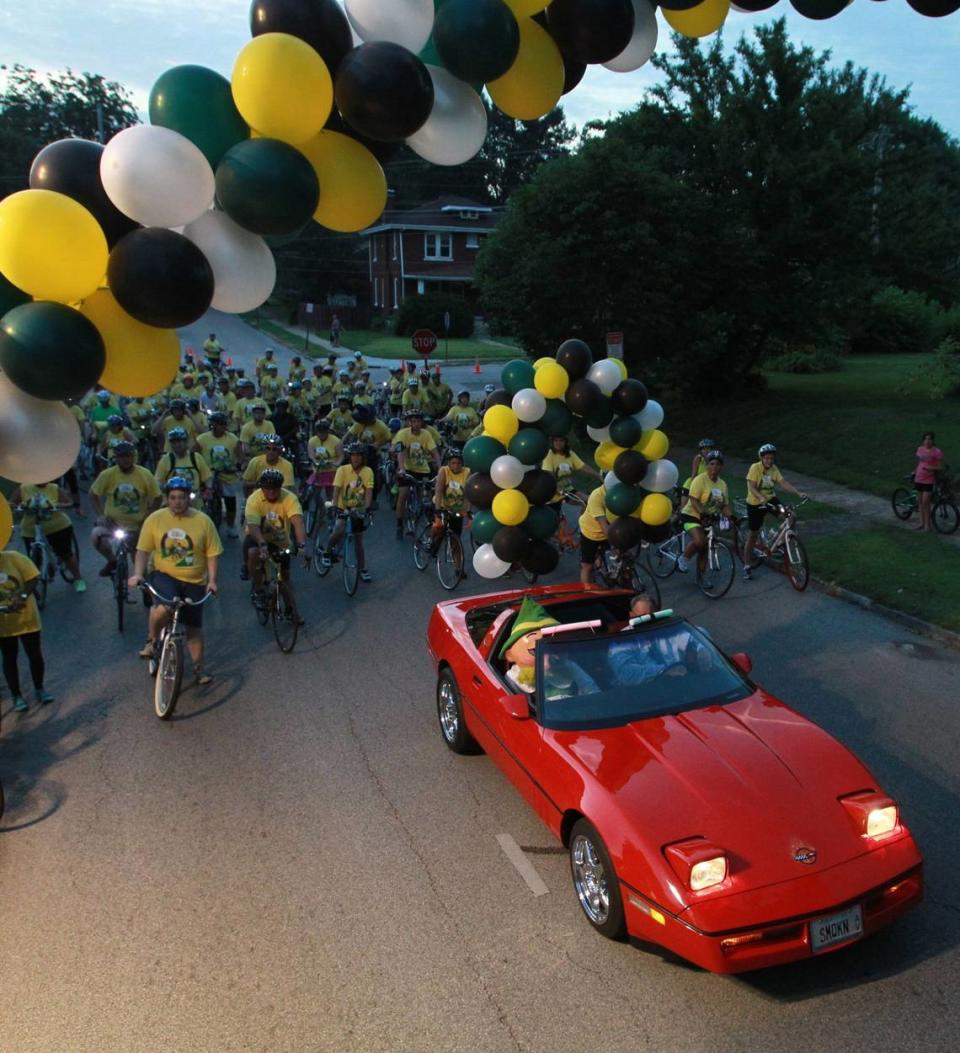 Belleville Mayor Mark Eckert and Otto, the city’s German mascot, lead bicyclists in a Corvette.