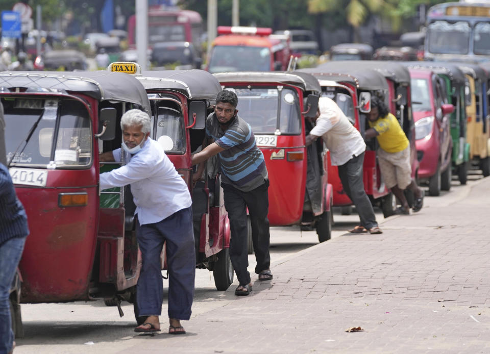 FILE - Auto rickshaw drivers line up to buy gas near a fuel station in Colombo, Sri Lanka, Wednesday, April 13, 2022. Sri Lanka’s Cabinet of ministers on Wednesday, June 28, 2023, approved a program to restructure staggering domestic debt as the island nation struggles to come out from an unprecedented economic crisis that has engulfed it since last year. (AP Photo/Eranga Jayawardena, File)
