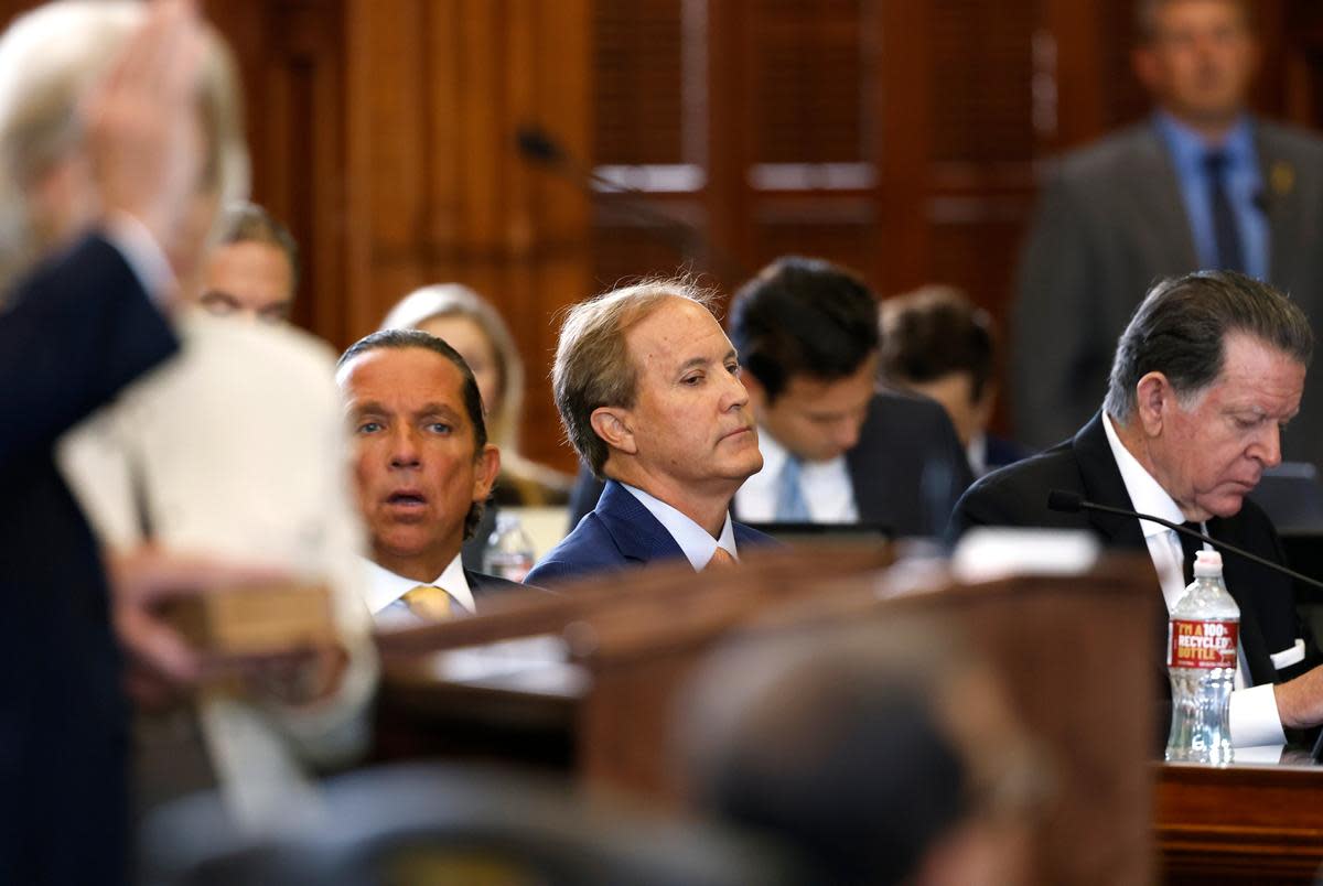 From left: Attorney Tony Buzbee, suspended Attorney General Ken Paxton and attorney Dan Cogdell on the Senate floor on Sept. 5, 2023. The attorneys are part of the team defending Paxton in his Senate impeachment trial.
