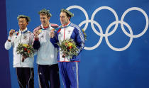 <b>Medal No. 4: </b>Takashi Yamaoto of Japan (far left), Michael Phelps of USA and Stephen Parry of Great Britain pose with their medals for the men's swimming 200m butterfly event on August 17, 2004 during the Athens 2004 Summer Olympic Games at the Main Pool of the Olympic Sports Complex Aquatic Centre in Athens, Greece.