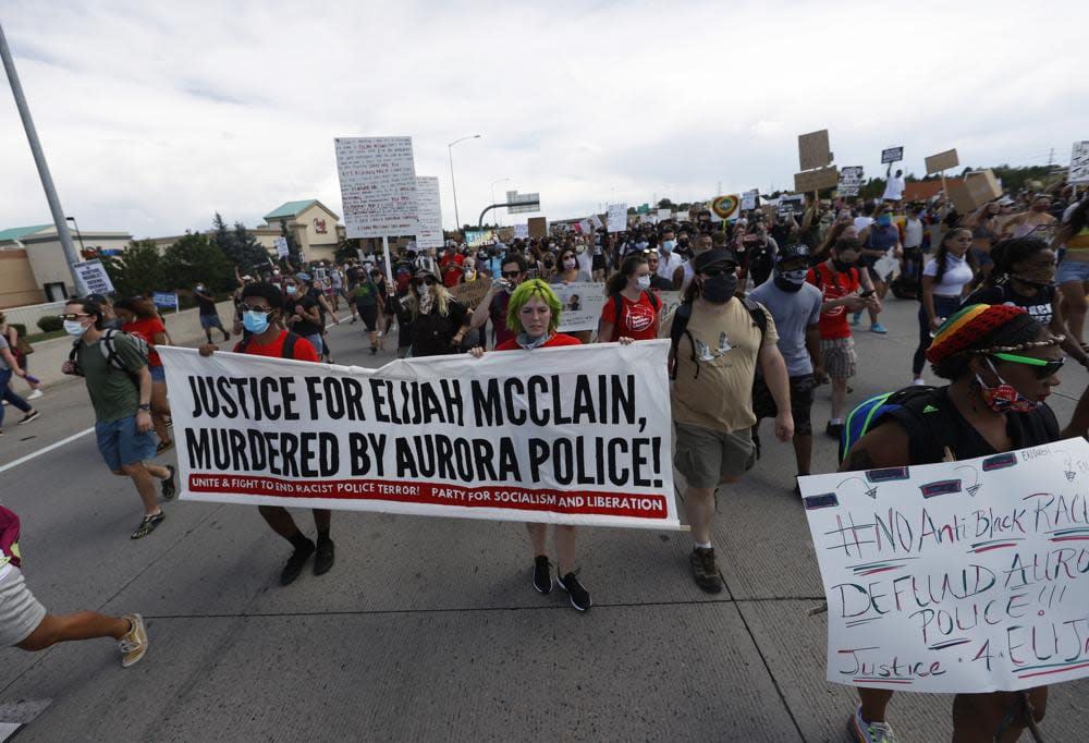 Demonstrators move along Interstate 225 after stopping traffic during a rally and march over the death of 23-year-old Elijah McClain, Saturday, June 27, 2020, in Aurora, Colo. (AP Photo/David Zalubowski, File)