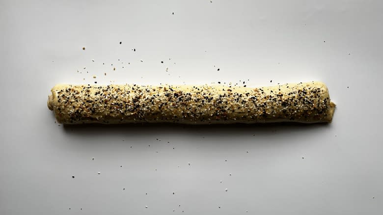 log of croissant dough sprinkled with seasoning
