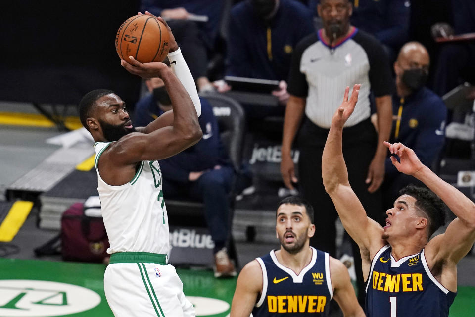 Boston Celtics guard Jaylen Brown, left, shoots over Denver Nuggets forward Michael Porter Jr. (1) and guard Facundo Campazzo, center, during the second half of an NBA basketball game, Tuesday, Feb. 16, 2021, in Boston. (AP Photo/Charles Krupa)