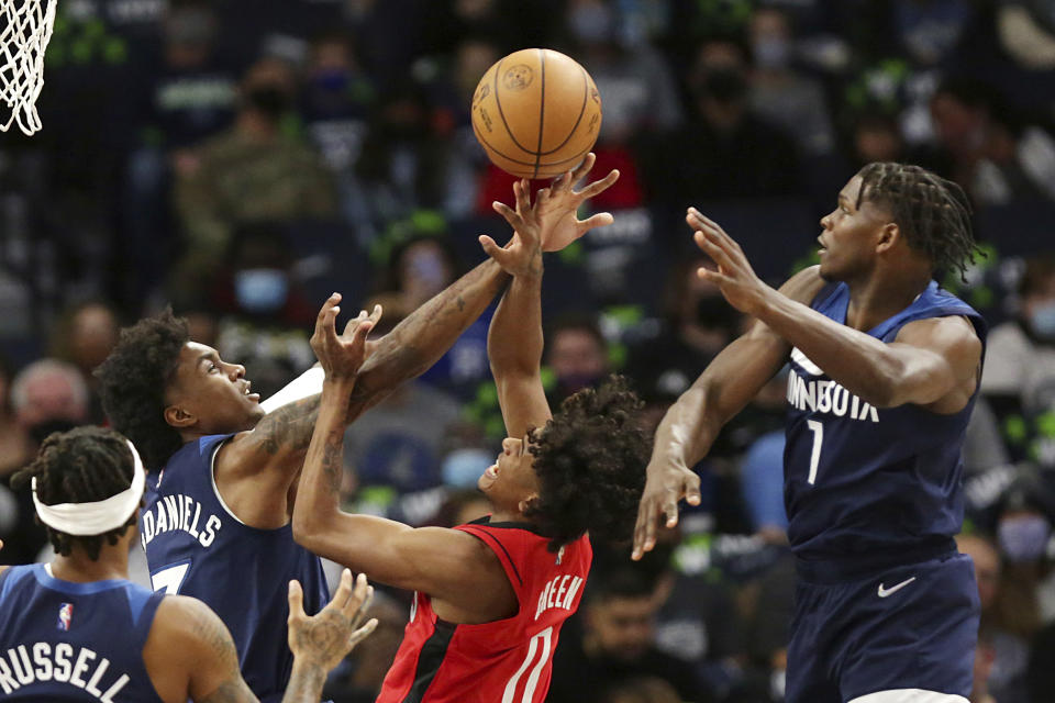 Houston Rockets guard Jalen Green (0) has a shot blocked by Minnesota Timberwolves forward Jaden McDaniels (3) with defense from Timberwolves forward Anthony Edwards (1) during the first half of an NBA basketball game Wednesday, Oct. 20, 2021, in Minneapolis. (AP Photo/Andy Clayton-King)