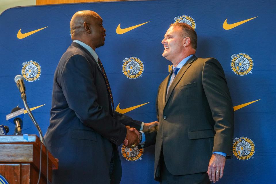 Steve Downing, Marian University director of athletics, shakes hands with Pat Knight, Marian’s new men’s basketball head coach, during a press conference, Friday, May 10, 2024, in the Peyton Manning Children’s Hospital Hall of Champions at Marian University in Indianapolis.