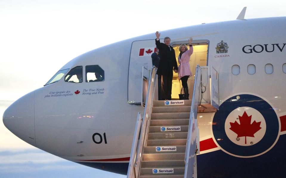 REFILE - CORRECTING PLANE MODEL Canada's Prime Minister Stephen Harper (L) and wife Laureen board the Royal Canadian Air Force Airbus CC-150 Polaris for a trip to Johannesburg, South Africa, to attend a public memorial for former South African President Nelson Mandela, in Ottawa December 8, 2013. REUTERS/Blair Gable (CANADA - Tags: POLITICS)