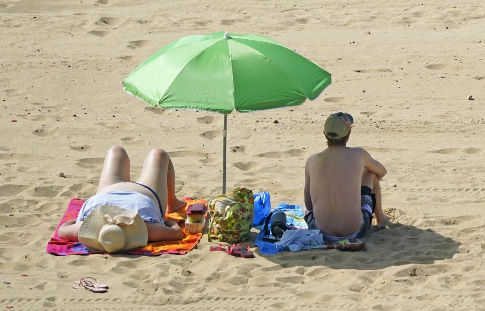 Relaxing in the hot weather on Bournemouth beach (Andrew Matthews/PA) (PA Wire)