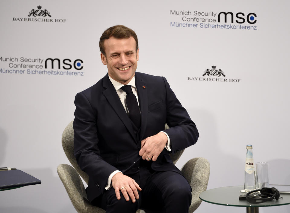 French President Emmanuel Macron smiles on the second day of the Munich Security Conference in Munich, Germany, Saturday, Feb. 15, 2020. (AP Photo/Jens Meyer)