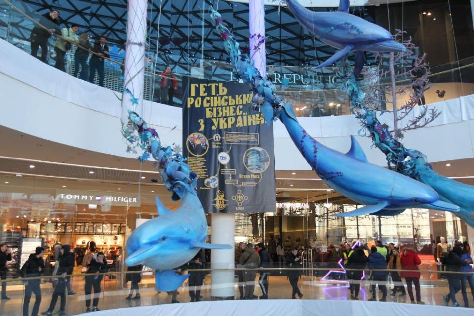 A banner reading ‘Get Russian business out of Ukraine!’ is seen during a protest against Russian business inside the Ocean Plaza shopping mall in Kyiv on Nov. 28, 2018. (STR/NurPhoto via Getty Images)