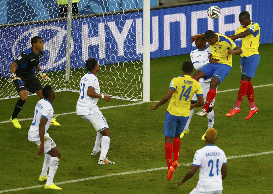 Ecuador's Enner Valencia (top R) heads the ball to score the team's second goal against Honduras during their 2014 World Cup Group E soccer match at the Baixada arena in Curitiba June 20, 2014. REUTERS/Amr Abdallah Dalsh (BRAZIL - Tags: SOCCER SPORT WORLD CUP TPX IMAGES OF THE DAY)