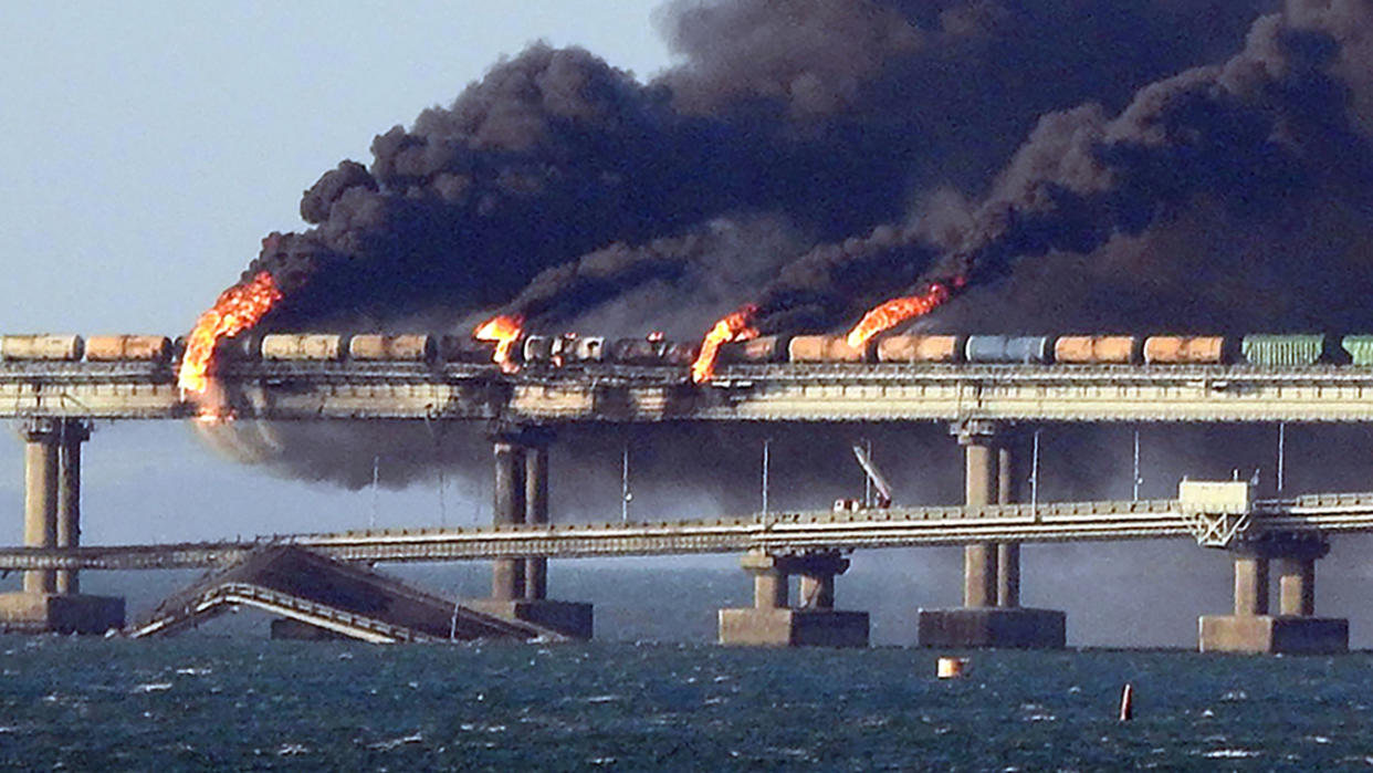 Smoke billows from Kerch Strait Bridge, which partially collapsed after an explosion.