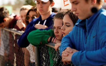 Students listen as former Columbine High School principal Frank DeAngelis speaks outside the school during a National School Walkout to honor the 17 students and staff members killed at Marjory Stoneman Douglas High School in Parkland, Florida, in Littleton, Colorado, U.S. March 14, 2018. REUTERS/Rick Wilking