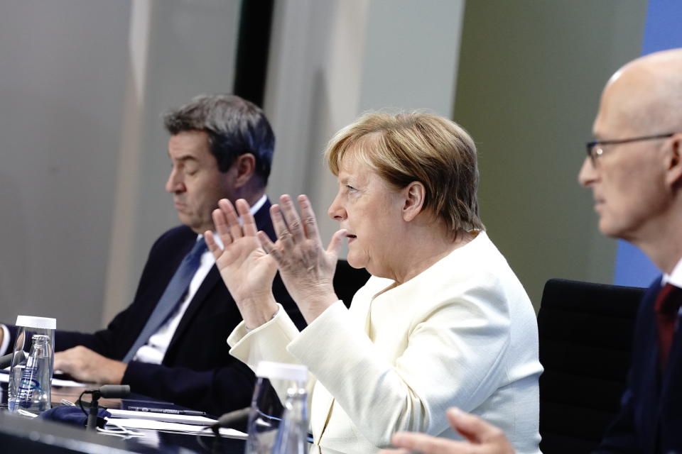 German Chancellor Angela Merkel, centre, Markus Soder, Prime Minister of Bavaria and CSU Chairman, left and Peter Tschentscher, the First Mayor of Hamburg, take part in a press conference, in Berlin, Tuesday, Sept. 29, 2020. Chancellor Angela Merkel and the governors of Germany’s 16 states conferred on how to prevent the country’s coronavirus infection figures from accelerating to the levels being seen in other European countries. (Kay Nietfeld/dpa via AP)