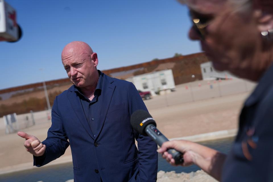 U.S. Sen. Mark Kelly speaks to the media about the barrier gaps at Morelos Dam on Aug. 10, 2022, in Yuma.