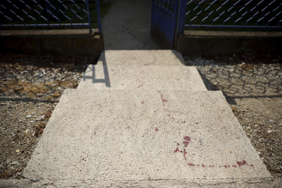 Blood is seen on the entrance of the school in the village of Dubona, some 50 kilometers (30 miles) south of Belgrade, Serbia, Friday, May 5, 2023. A shooter killed multiple people and wounded more in a drive-by attack late Thursday in Serbia's second such mass killing in two days, state television reported. (AP Photo/Armin Durgut)