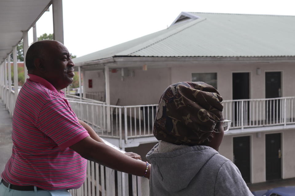 Dana Williams and his daughter De'mai Williams stand outside a low-cost hotel in Atlanta on May 18, 2023. The two have been looking for an affordable place to live ever since they were evicted from their two-bedroom apartment in April. (AP Photo/R.J. Rico)