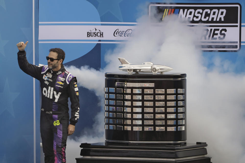 Jimmie Johnson gives a thumbs-up to fans as he is introduced to the crowd before the NASCAR Daytona 500 auto race Sunday, Feb. 16, 2020, at Daytona International Speedway in Daytona Beach, Fla. Johnson is making his last Daytona 500 start. (AP Photo/Chris O'Meara)