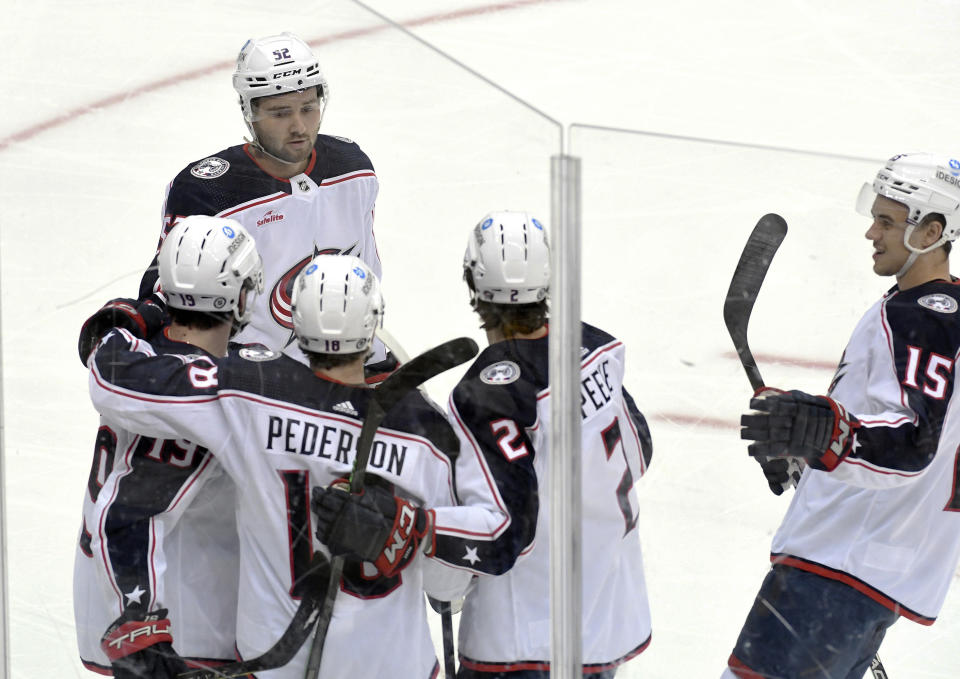 Columbus Blue Jackets defenseman Lane Pederson (18) celebrates a goal with center Liam Foudy (19), right wing Emil Bemstrom (52), defenseman Andrew Peeke (2), and defenseman Gavin Byreuthyer against the Pittsburgh Penguins during the first period of an NHL hockey game, Tuesday, March 7, 2023, in Pittsburgh. (AP Photo/Philip G. Pavely)