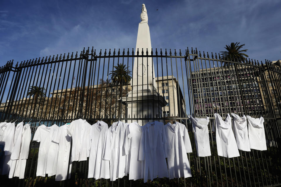 This July 15, 2018 photo shows white medical coats hanging from the iron gate that surrounds the national monument May Pyramid, as a symbolic act against efforts to legalize abortion, in Buenos Aires downtown, Argentina. While the Doctors for Life activist group claims about 1,000 members, only a small fraction of the country's physicians, its protests are feeding a debate in the profession as a whole about the move to legalize elective abortions in the first 14 months of pregnancy. (AP Photo/Jorge Saenz)