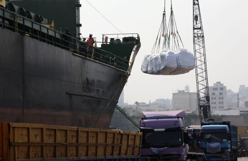 Humanitarian aid donated by World Food Program (WFP), are unloaded from a ship at Beirut's port