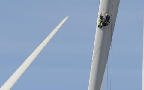 Two windfarm employees working on a blade on the Lynemouth Windfarm in Northumberland, illustrating the sheer scale of the turbines. - Credit: Raoul Dixon / NNP&nbsp;