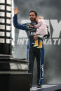 DAYTONA BEACH, FL - FEBRUARY 26: Jimmie Johnson, driver of the #48 Lowe's Chevrolet, waves to fans while holding daughter Genevieve Marie during driver introductions prior to the start of the NASCAR Sprint Cup Series Daytona 500 at Daytona International Speedway on February 26, 2012 in Daytona Beach, Florida. (Photo by Jerry Markland/Getty Images for NASCAR)