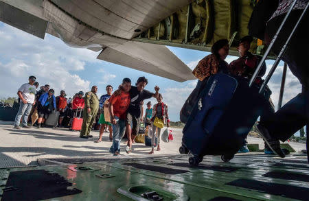 People injured or affected by the earthquake and tsunami are evacuated on an airforce plane in Palu, Central Sulawesi, Indonesia, September 30, 2018. Antara Foto/Muhammad Adimaja via REUTERS
