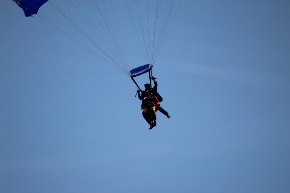 Bowley Elementary School Principal Latonya Leeks, with her tandem skydiving partner retired Master Sgt. Sunnydale Hyde, come in for a landing at Polo Field on Fort Bragg on Friday, May 12, 2023. Leeks said she would jump from a plane if her students met their reading goal for March. They exceeded the goal.