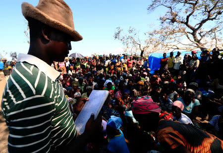 People wait to receive aid at a camp for the people displaced in the aftermath of Cyclone Idai in John Segredo near Beira, Mozambique March 31, 2019. REUTERS/Zohra Bensemra??
