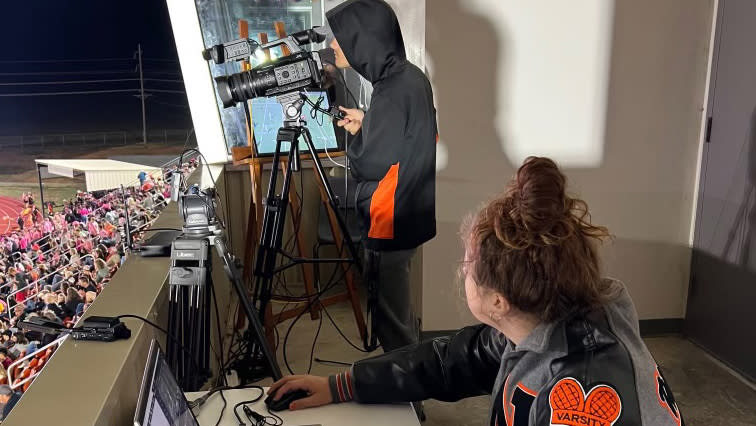  A camera man using JVC cameras at a high school football game. . 