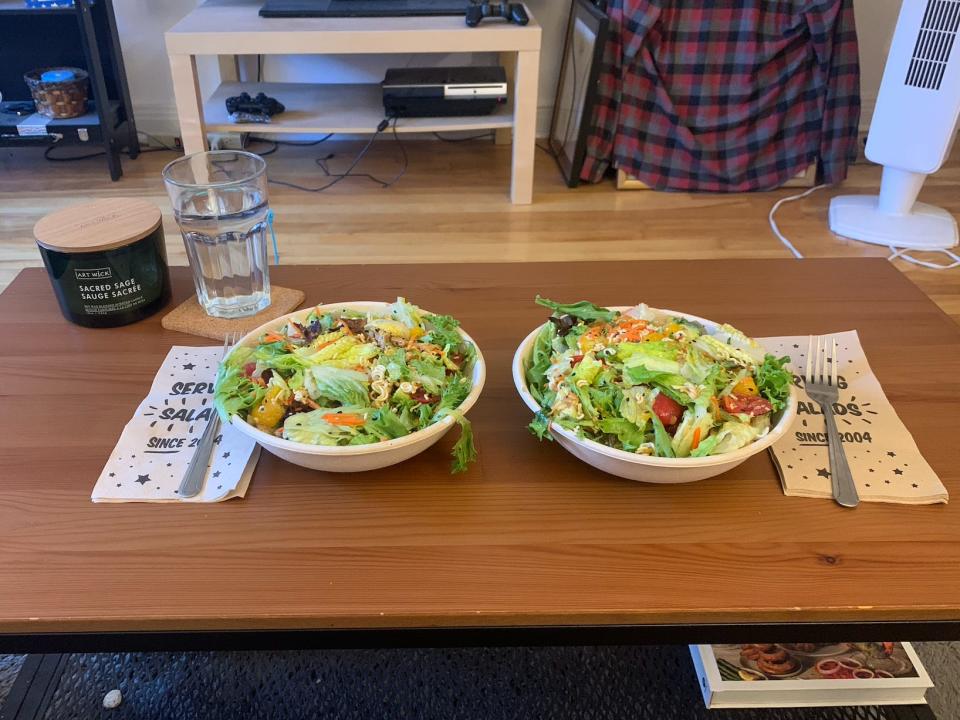 two bowls of salad on a living room coffee table