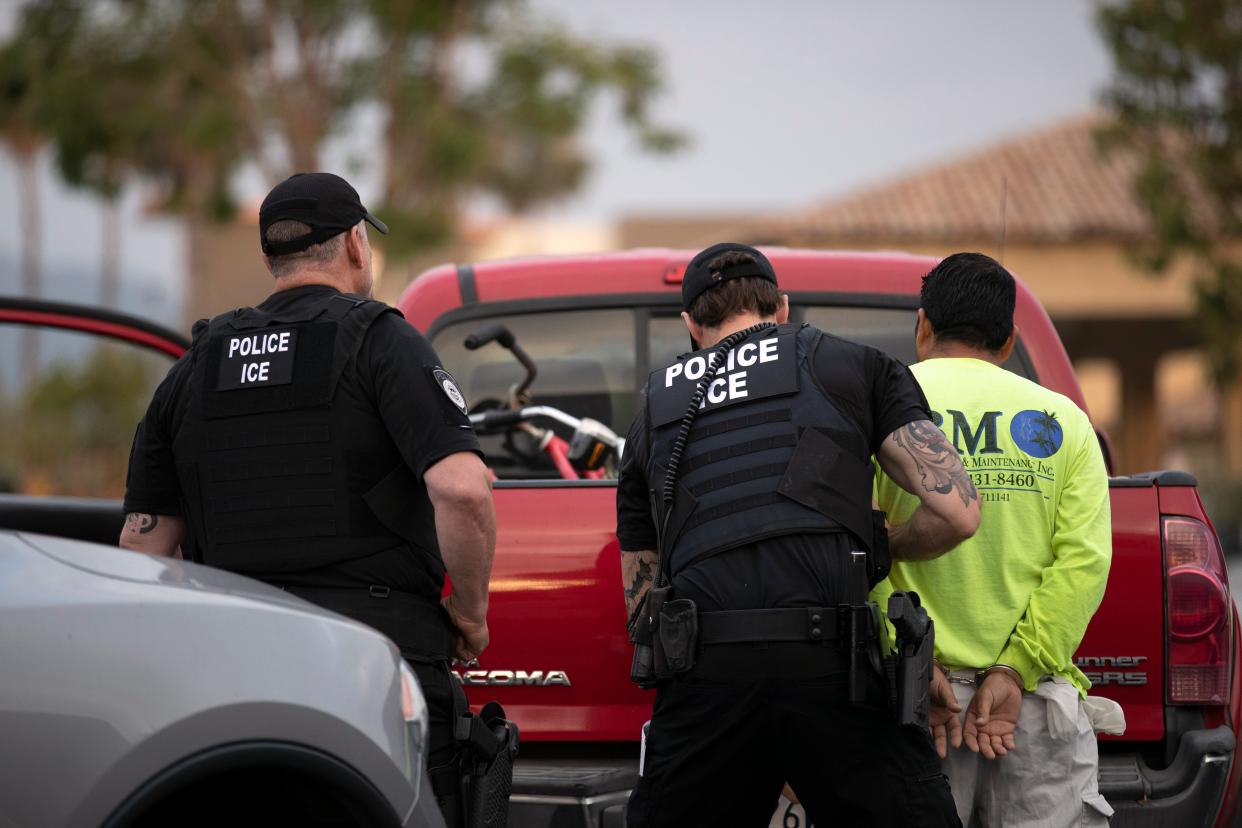 <p>A 2019 photo captures US Immigration and Customs Enforcement officers detaining a man in California.</p> (AP)