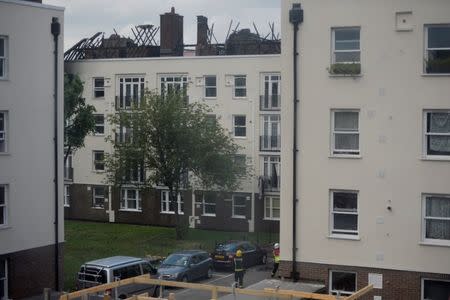 Damage can be seen to the roof of a low-rise block of buildings affected by a fire in Bethnal Green, northeast London, Britain, June 24, 2017. REUTERS/Hannah McKay