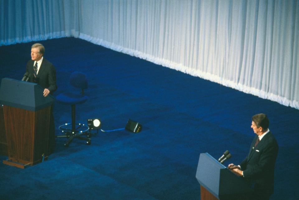 President Jimmy Carter, left, and his Republican challenger, Ronald Reagan, stand at their lecterns answering questions during a 1980 debate in Cleveland. <a href="https://www.gettyimages.com/detail/news-photo/president-carter-and-his-republican-challenger-ronald-news-photo/515169438?adppopup=true" rel="nofollow noopener" target="_blank" data-ylk="slk:Bettmann / Getty Images;elm:context_link;itc:0;sec:content-canvas" class="link ">Bettmann / Getty Images</a>