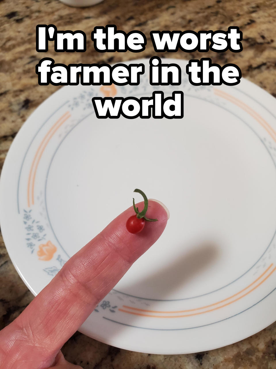 tiny tomato on a finger