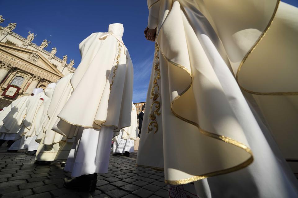 Prelates arrive for a mass presided over by Pope Francis and concelebrated by the new cardinals for the start of the XVI General Assembly of the Synod of Bishops in St. Peter's Square at The Vatican, Wednesday, Oct.4, 2023. Pope Francis is convening a global gathering of bishops and laypeople to discuss the future of the Catholic Church, including some hot-button issues that have previously been considered off the table for discussion. Key agenda items include women's role in the church, welcoming LGBTQ+ Catholics, and how bishops exercise authority. For the first time, women and laypeople can vote on specific proposals alongside bishops (AP Photo/Andrew Medichini)