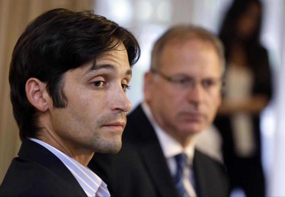 Plaintiff Michael Egan, left, with his attorney, Jeff Herman take questions from to the media during a news conference in Beverly Hills, Calif., Thursday, April 17, 2014. A sex abuse lawsuit by Egan, a former child model and aspiring actor is accusing "X-Men" franchise director Bryan Singer of sexually abusing him as a teenager in a federal lawsuit filed in Hawaii. Singer's attorney, Marty Singer, said in a statement that the claims are absurd and defamatory. (AP Photo/Damian Dovarganes)