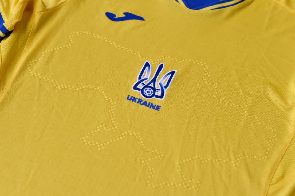 A picture taken on June 6, 2021 shows a EURO 2020 jersey of the Ukrainian national football team. - Ukraine provoked Moscow's ire on June 6, 2021 as its football federation unveiled Euro 2020 uniforms that feature Russian-annexed Crimea and nationalist slogans. The uniforms in the blue-and-yellow colours of the Ukrainian flag feature the silhouette of Ukraine that includes Russia-annexed Crimea and the separatist-controlled regions of Donetsk and Lugansk as well as the words 
